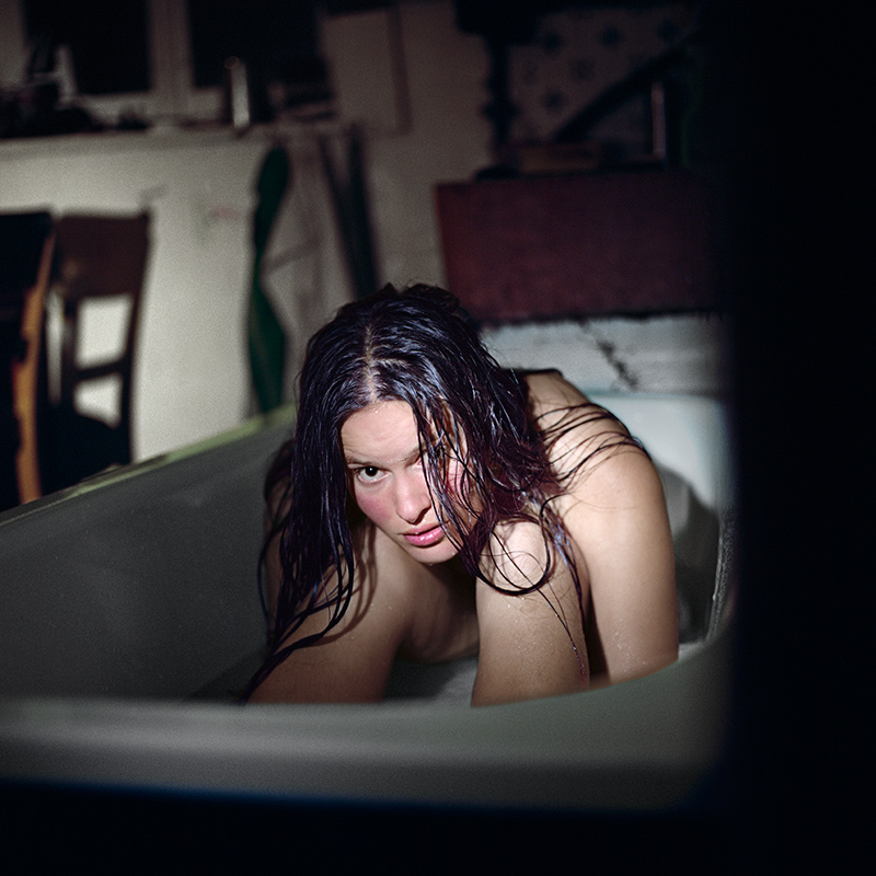 Nude woman sitting in the bathtub