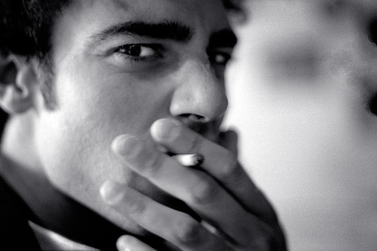 Young man smoking and having a glance